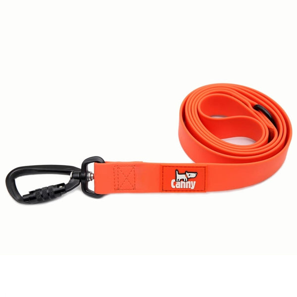 Orange waterproof and odourless dog lead with locking carabiner clip, coiled and displayed on a white background.